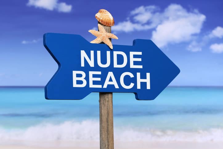 a sign pointing to nude beaches in Florida