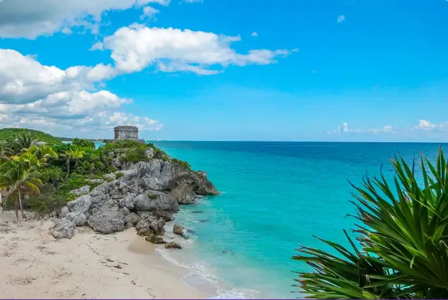 Scenic view of Costa Maya Mexico with turquoise Caribbean waters, palm trees, and coastal ruins featured on the Temptation Swinger Travel Cruise March 2026 for couples only