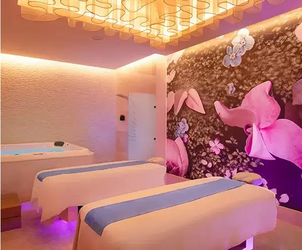 Luxurious couples massage room at Desire Riviera Maya Allure Spa with warm lighting and private jacuzzi, couples only all inclusive resort in the Riviera Maya
