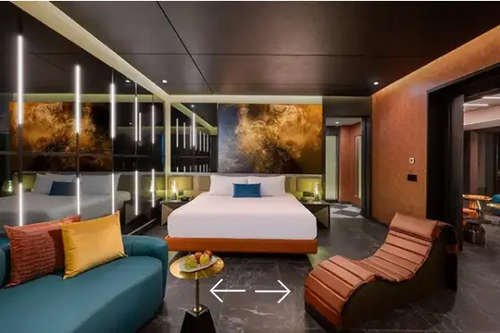 Modern bedroom interior of the Desire Suite at Desire Riviera Maya featuring king bed, sensual lounge chair, and ambient lighting, couples only all inclusive resort in the Riviera Maya