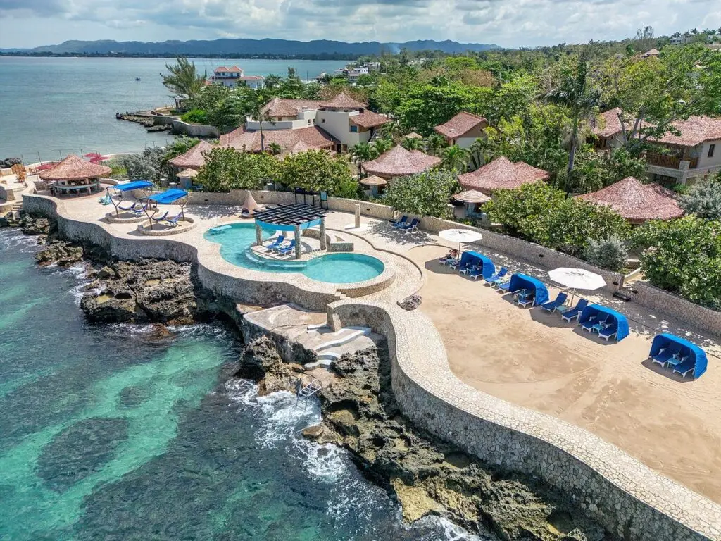 Oceanfront pool and sun loungers overlooking the Caribbean Sea at Grand Lido Nude Luxury Resort Jamaica