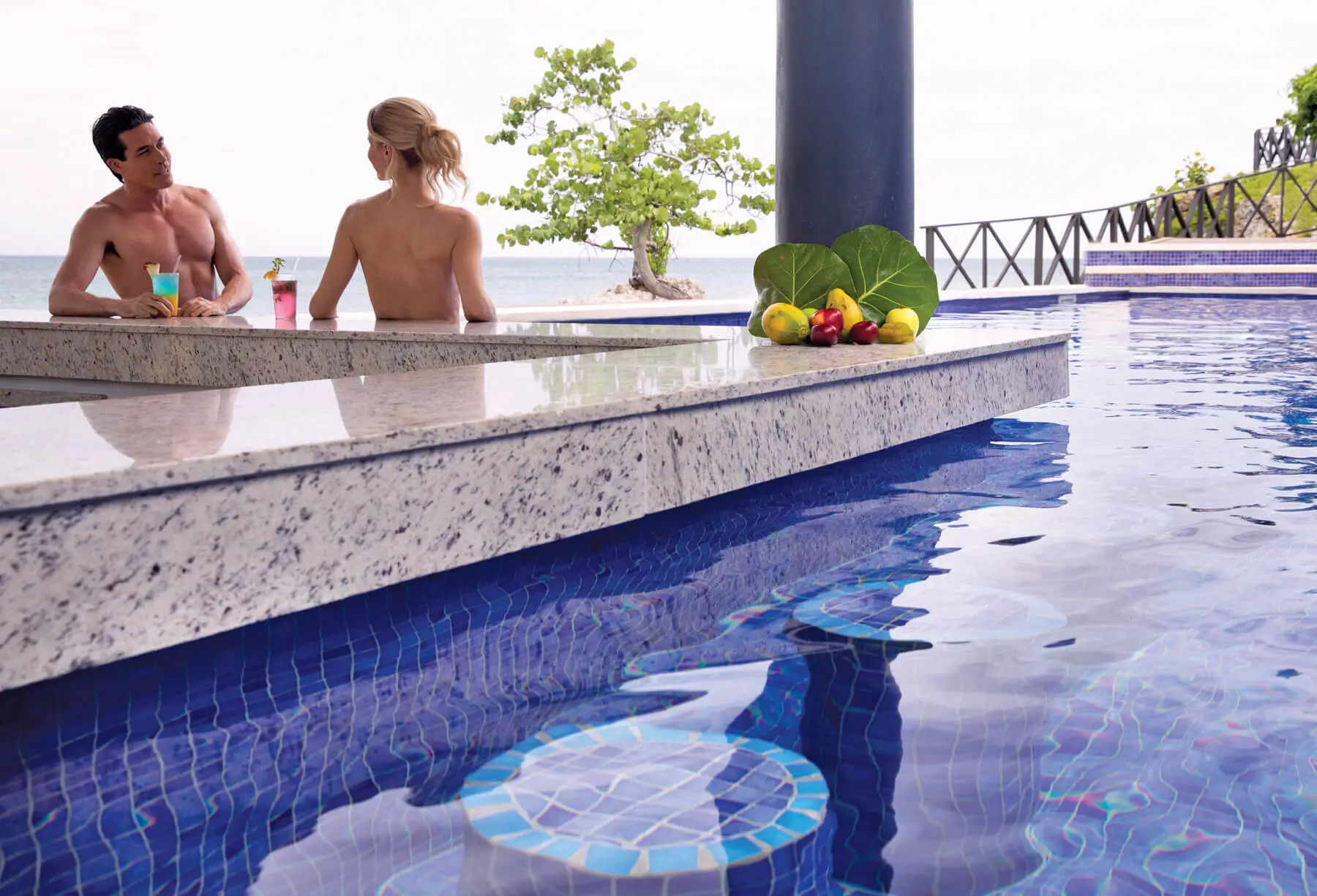 Swim-up bar at Grand Lido Nude Luxury Resort Jamaica with cocktails, ocean views, and relaxed Caribbean vibes