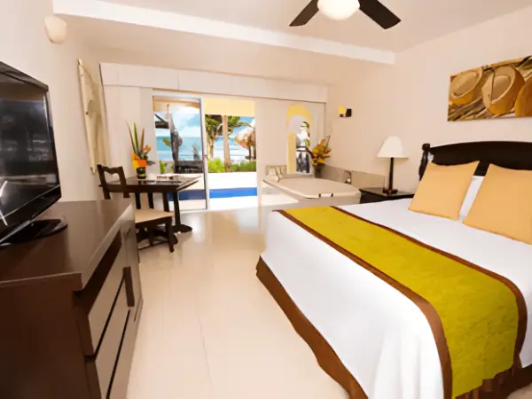 Luxurious oceanfront junior suite with a hot tub, patio, and pool access at Hidden Beach Riviera Maya for a nude hotel takeover experience.