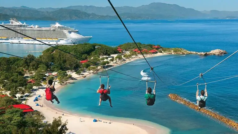 Zip line riders over turquoise water and beach at Labadee Haiti, a port of call on Bliss Cruise Celebrity Silhouette April 2027