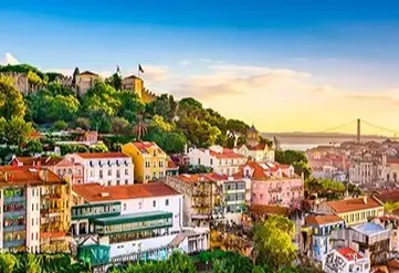 View over Lisbon Portugal with historic rooftops and river at sunset featured on Desire Lisbon Morocco 2027