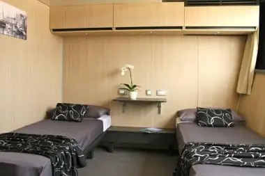 Modern premium twin cabin aboard the MV Majestic with light wood interiors and stylish touches, part of the 2026 Southern European Naturist Nude Cruise itinerary sailing across the Adriatic Sea.