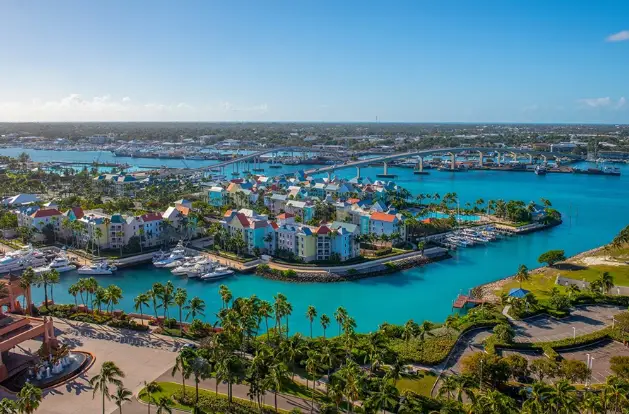 Aerial view of Nassau Bahamas with colorful waterfront buildings and marinas, featured on the Temptation Lifestyle Cruise 2026