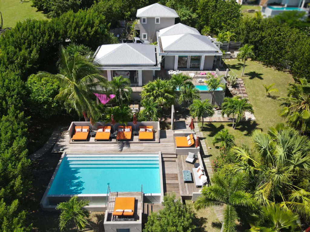 Aerial view of La Villa with private pools, sun loungers, and tropical landscaping at a nude clothing optional Caribbean adult-only resort