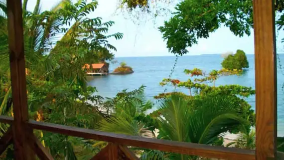 View from a private balcony overlooking the ocean and tropical jungle at a clothing optional resort in Panama