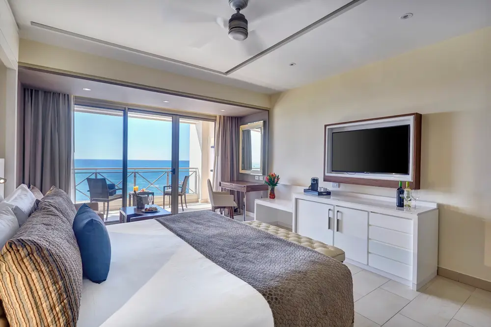 Sunset Ocean View Suite at Grand Lido Jamaica nude luxury resort with king bed, jacuzzi, and balcony overlooking the Caribbean Sea