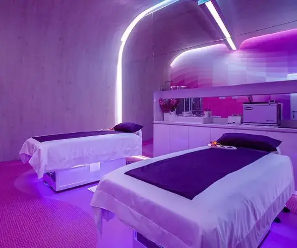 Couples massage room at Spa Rosé inside Temptation Cancun Resort, an adults-only all-inclusive destination with modern design and purple lighting