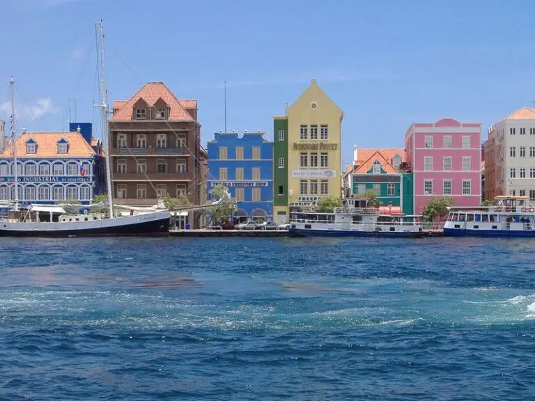 Bright Dutch colonial buildings along the waterfront in Willemstad Curacao, a stop on Bliss Cruise Wonder of the Seas 2026
