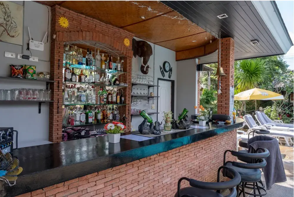 Outdoor bar at Harmony Naturist Resort Phuket with tropical seating and poolside views