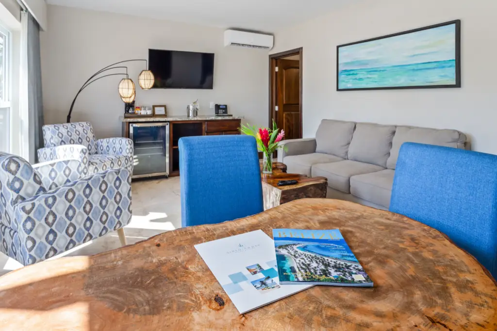 View from the Sand Dollar Bungalow overlooking Sirenian Bay resort grounds, palm trees from the living room during the Nude Takeover 2026 in Belize