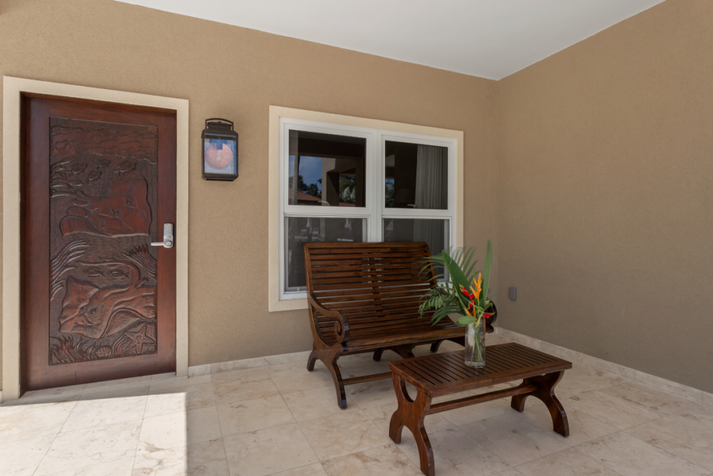 Private covered patio outside the Stingray Bungalow with seating and tropical accents, perfect for relaxed nude friendly lounging during Nude Takeover 2026