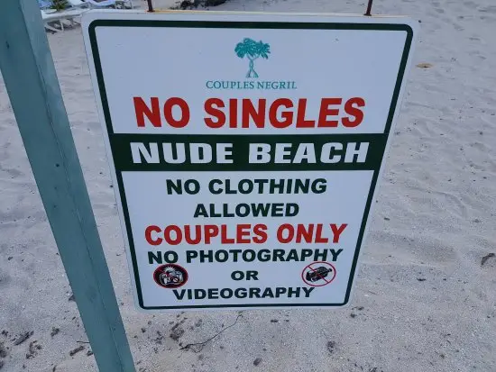 Couples Negril nude beach sign showing clothing optional couples only area in Jamaica for honeymoon and anniversary travel