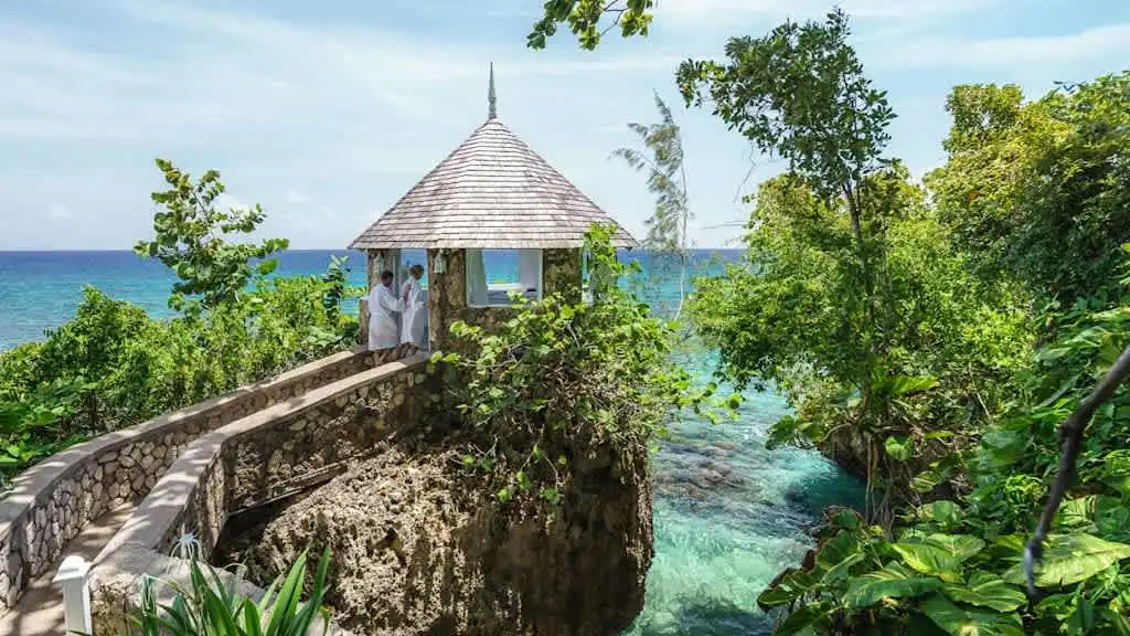 Couples Sans Souci Ocho Rios Jamaica cliffside gazebo overlooking turquoise water, adults only all inclusive honeymoon and anniversary resort