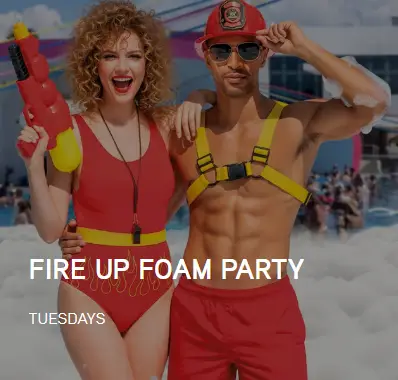 couple in red lifeguard themed outfits at Temptation Cancun foam pool party adults only lifestyle resort
