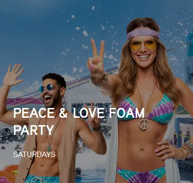 woman in colorful bikini and peace sign at Temptation Cancun foam party adults only lifestyle resort