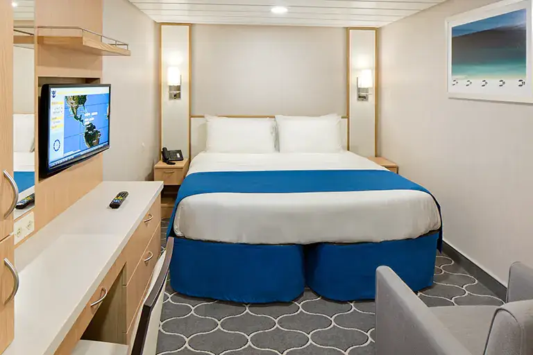 Interior stateroom with queen bed and modern furnishings on Mariner of the Seas, Bliss Cruise February 2028 New Orleans adults only cruise