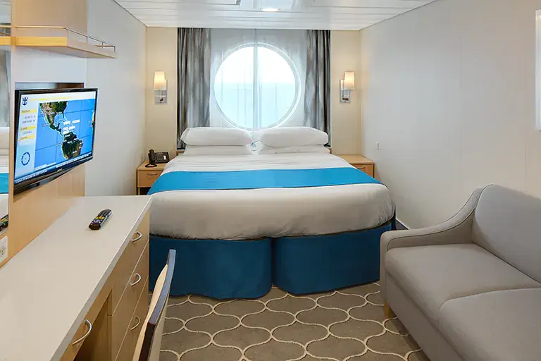 Ocean view stateroom with round window and queen bed on Mariner of the Seas, Bliss Cruise February 2028 New Orleans adults only