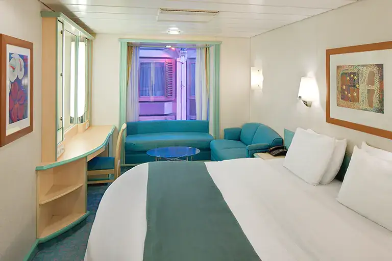 Promenade view interior stateroom with bed, seating area, and interior window view on Mariner of the Seas, Bliss Cruise February 2028 New Orleans adults only