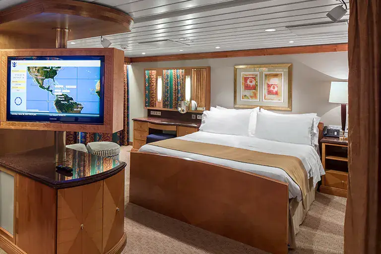 Owners suite bedroom with king bed and luxury finishes on Mariner of the Seas, Bliss Cruise February 2028 New Orleans nude swinger cruise