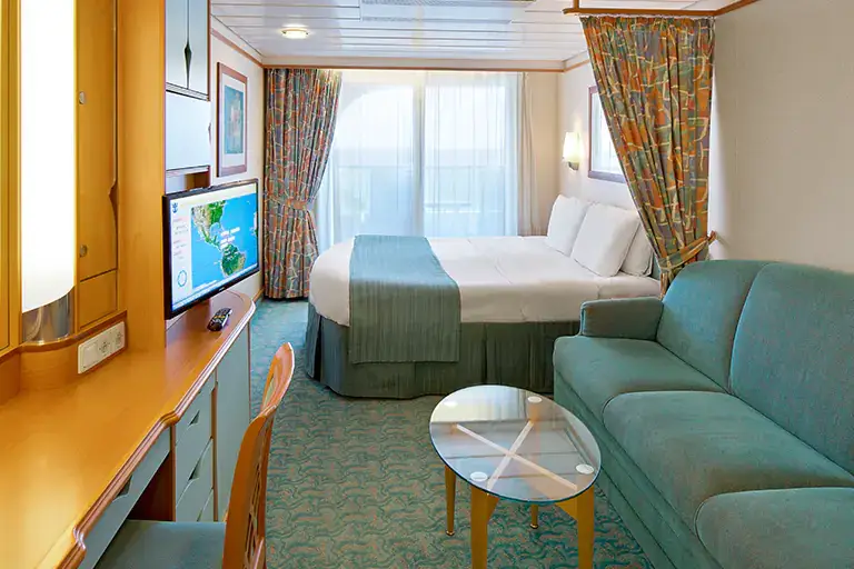 Spacious ocean view balcony stateroom with seating area and large window on Mariner of the Seas, Bliss Cruise February 2028 New Orleans adults only cruise