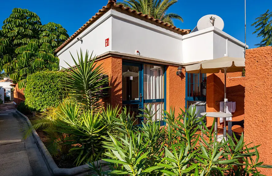 Nude resort Spain Canary Islands bungalow accommodation featuring a private terrace, tropical landscaping, and apartment style lodging