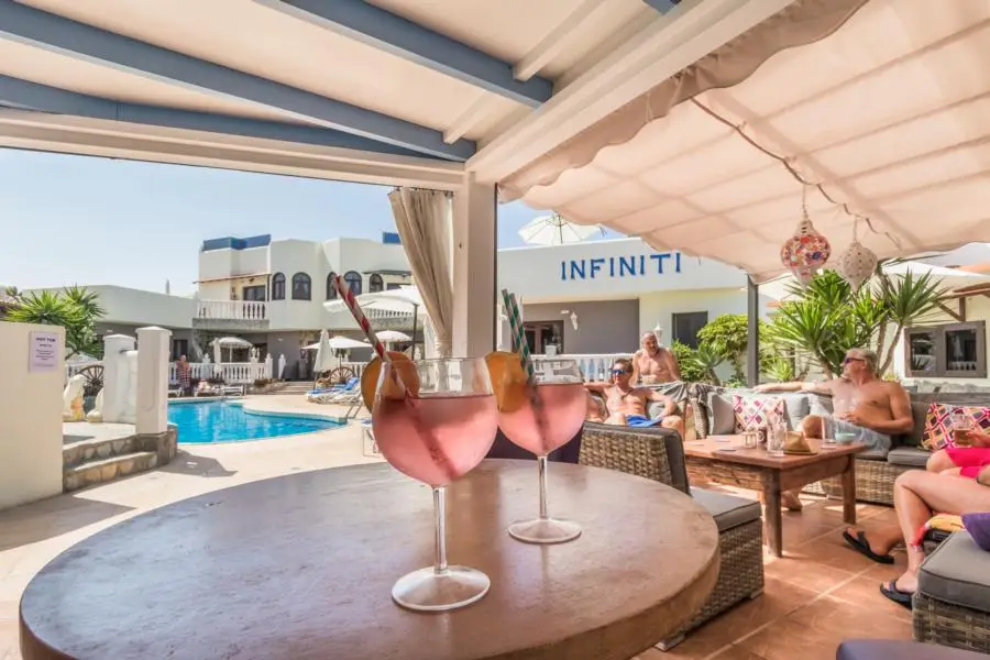 Nude resort Spain Fuerteventura Sun Club pool bar and social area with outdoor seating and tropical resort atmosphere