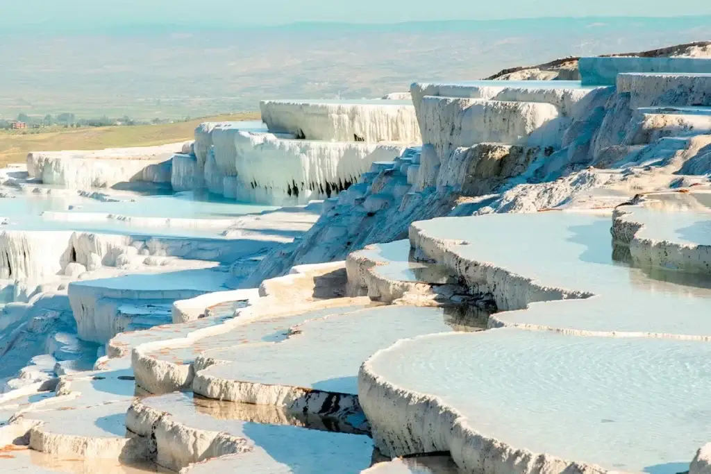 The white thermal terraces of Pamukkale, Turkey, a popular shore excursion during an adults only lifestyle group trip sailing Greece, Turkey, and Cairo aboard Virgin Voyages.