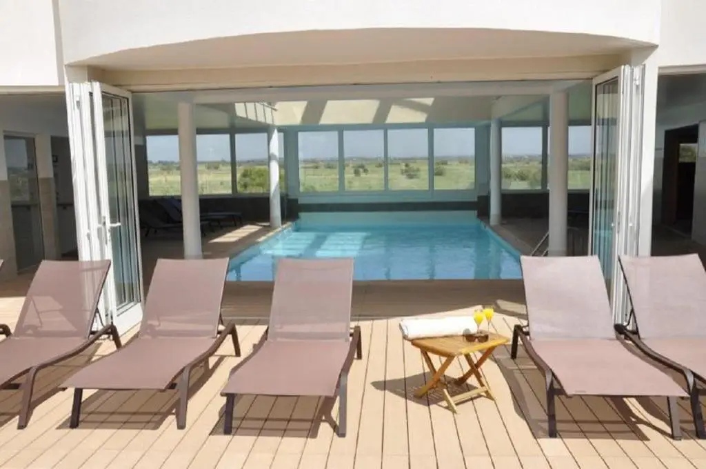 Indoor swimming pool and sun deck at Natureva Spa in Nude City France, located within Cap d'Agde Naturist Village.