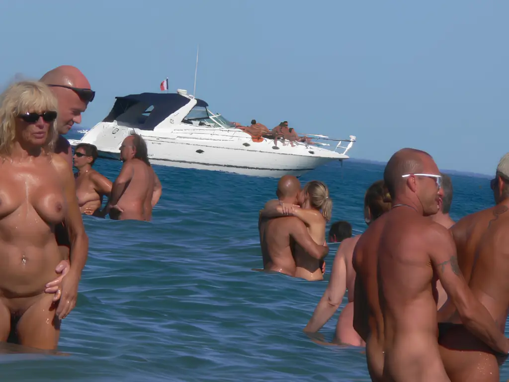 Naturist travelers enjoying a nude beach vacation in Cap d’Agde, France